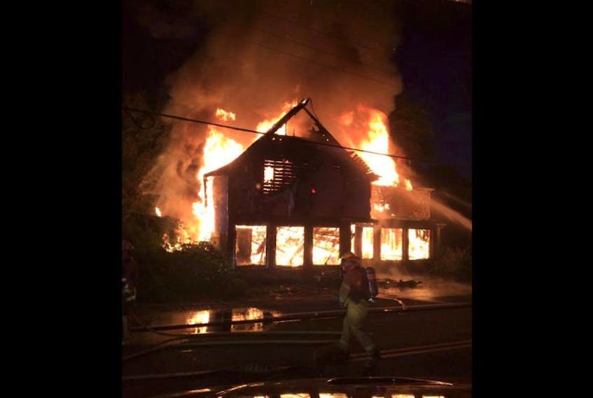 ['An image from the Deep Brook fire showing the old general store aflame. The fire eventually burned it to the ground. All three incidents are currently active RCMP arson investigations.']