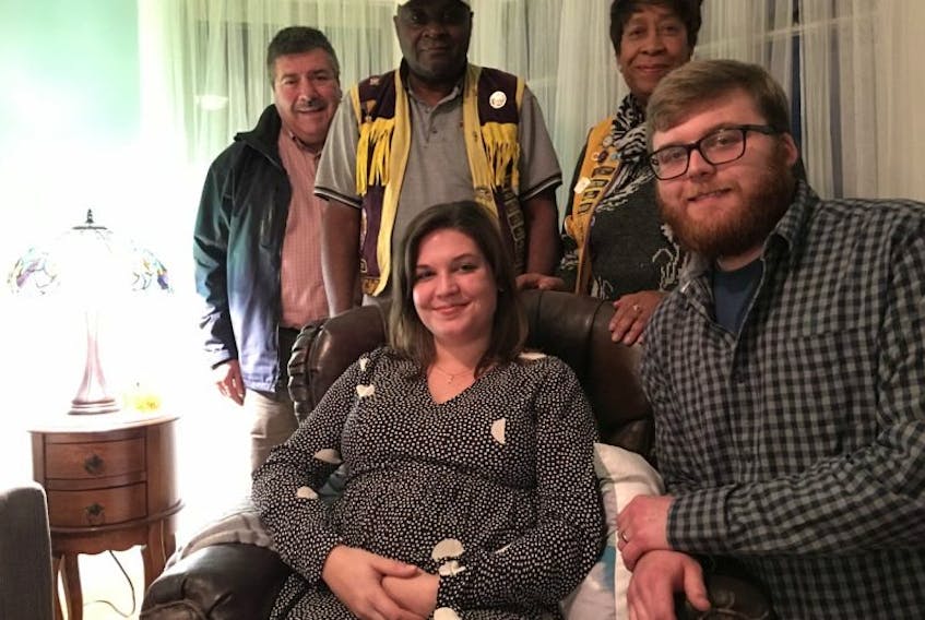 Lions Mike Clayton, Charlie and Sandra Blake stand behind Caroline and Derek Robertson… in more ways than one. The Yarmouth Lions Club is fundraising to help the couple with mounting medical costs.