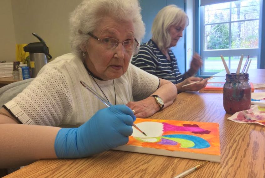 Gwen Ogilvie and Sandie Mackenzie paint their canvases at the senior's art class at the Mckay Memorial Library in Shelburne. 