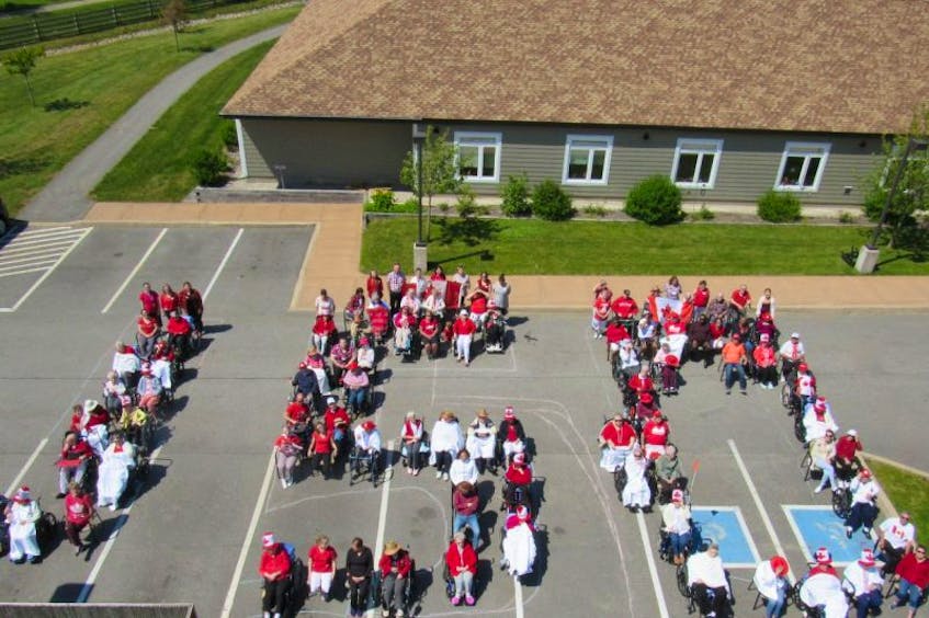 Seniors and their helpers at the Meadows Home for Special Care came out to show their national pride earlier this month by wearing red and sitting in the shape of the number 150.