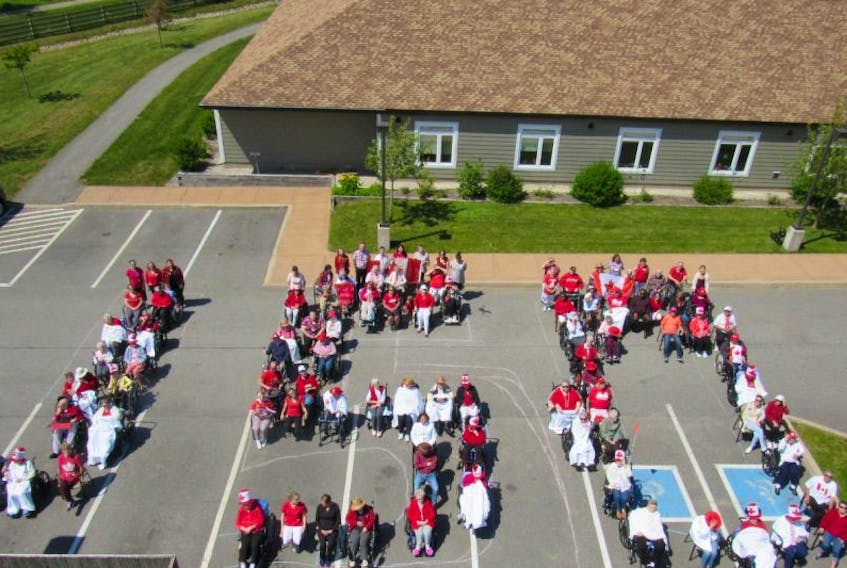 Seniors and their helpers at the Meadows Home for Special Care came out to show their national pride earlier this month by wearing red and sitting in the shape of the number 150.