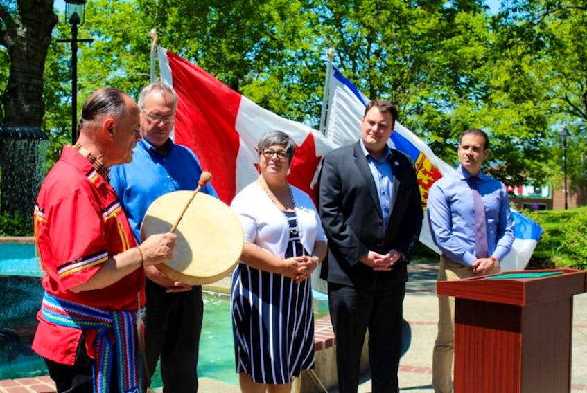 Leland Surette, Aboriginal spiritual leader, performs a song in Frost Park in Yarmouth Monday, June 26, prior to a Canada 150 funding announcement by West Nova MP Colin Fraser. Looking on (from left after Surette) are Digby Mayor Ben Cleveland, Yarmouth Mayor Pam Mood, West Nova MP Colin Fraser and Yarmouth MLA and Nova Scotia cabinet minister Zach Churchill.