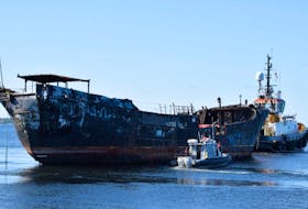 The Coast Guard’s fast response craft goes alongside the Farley Mowat to pick up two workers who stayed with the derelict vessel until it cleared the wharf.  