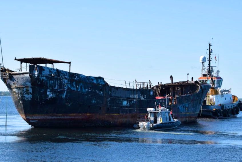 The Coast Guard’s fast response craft goes alongside the Farley Mowat to pick up two workers who stayed with the derelict vessel until it cleared the wharf.  